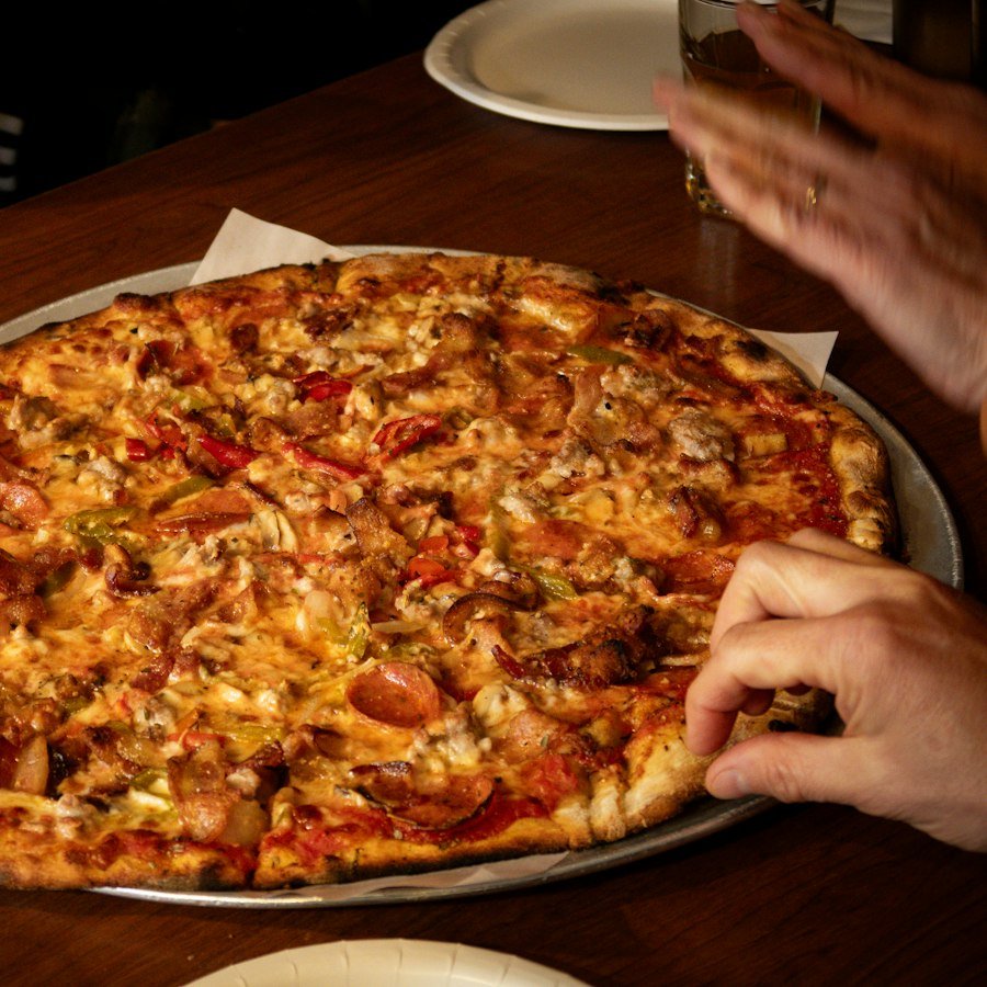 Meat Feast Pizza Market Deeping with chicken tikka, chicken and donner from Eastern Promise
